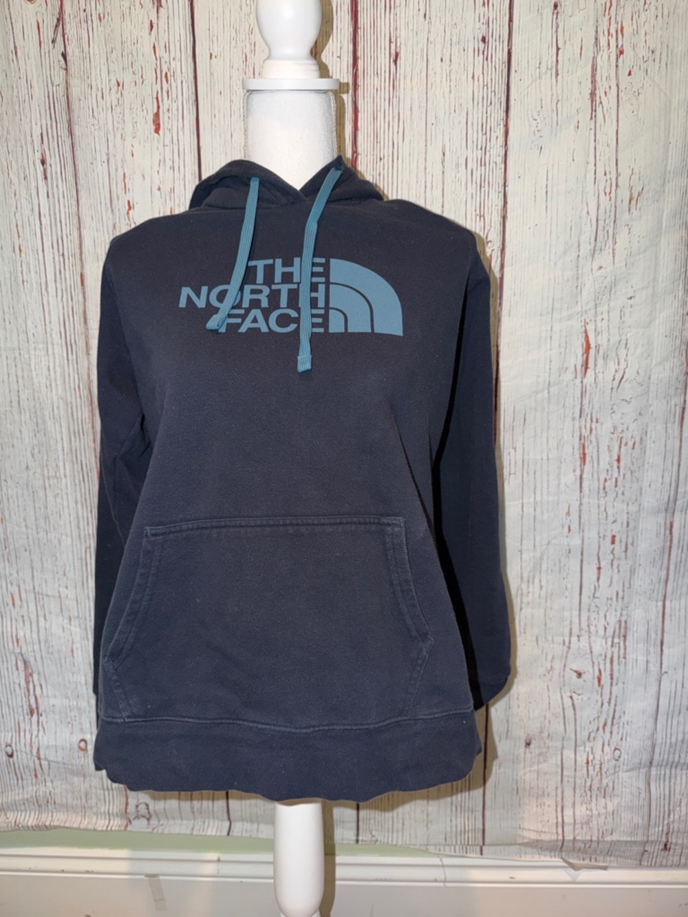 The North Face woman’s Dark Navy Pullover Hoodie with Light Blue Logo